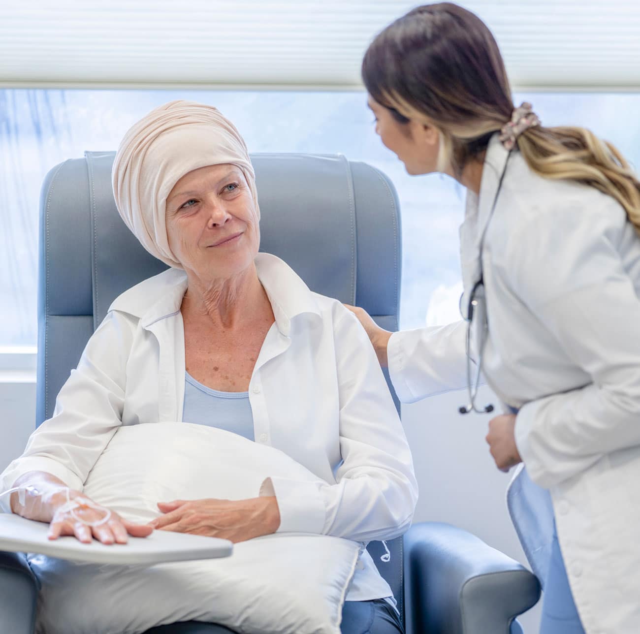 Woman doctor speaking with female patient