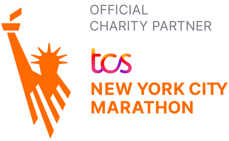 The image shows the Statue of Liberty’s stylized torch and head in orange, with text reading “OFFICIAL CHARITY PARTNER” above, and “tcs NEW YORK CITY MARATHON” in orange and grey beside the graphic.