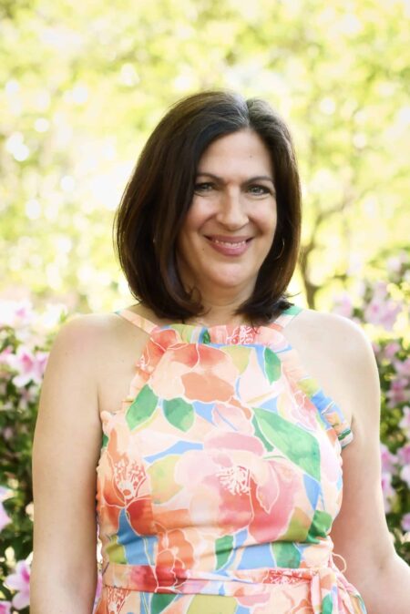 May contain a person wearing a colorful floral dress outdoors.